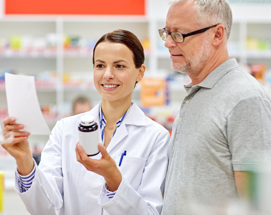 pharmacist and costumer reading prescription
