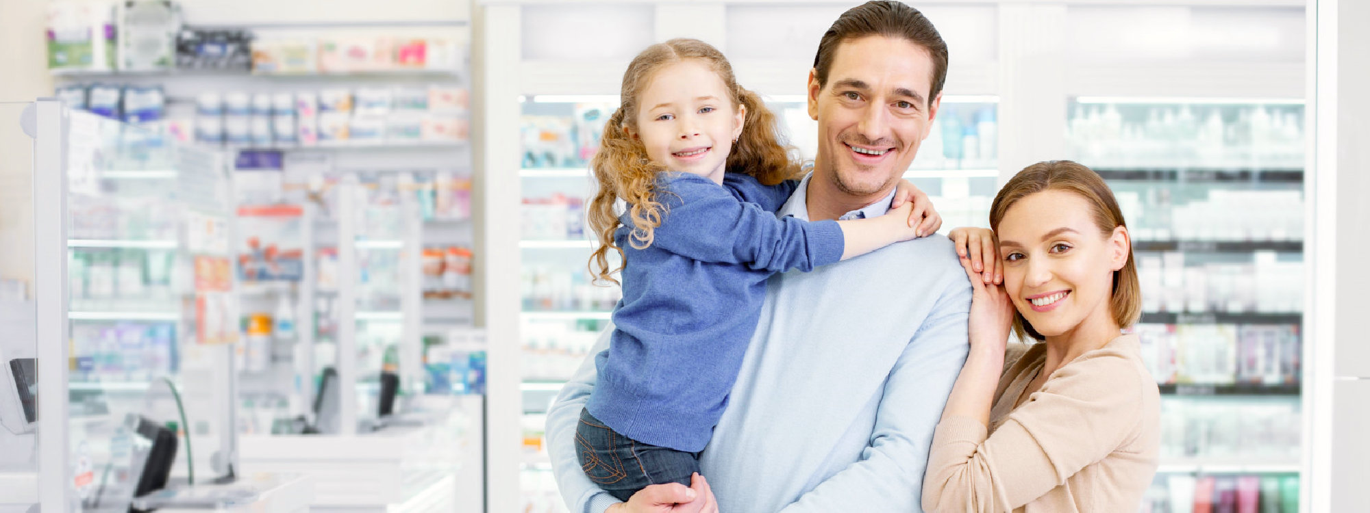 family inside pharmacy smiling