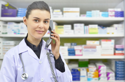 smiling female pharmacist talking to someone on phone